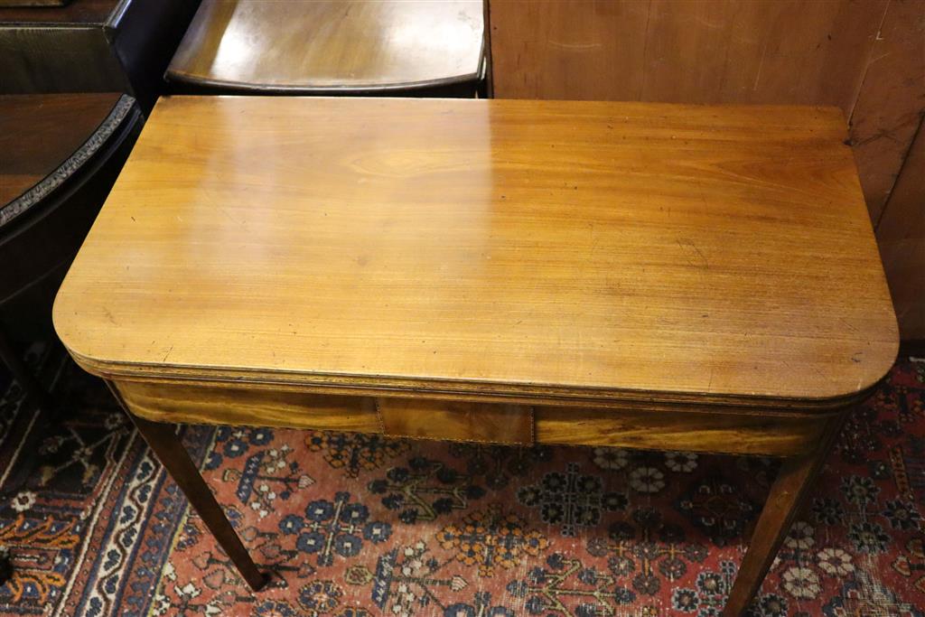 A George III mahogany folding top D-shaped tea table, width 91cm, depth 45cm, height 73cm